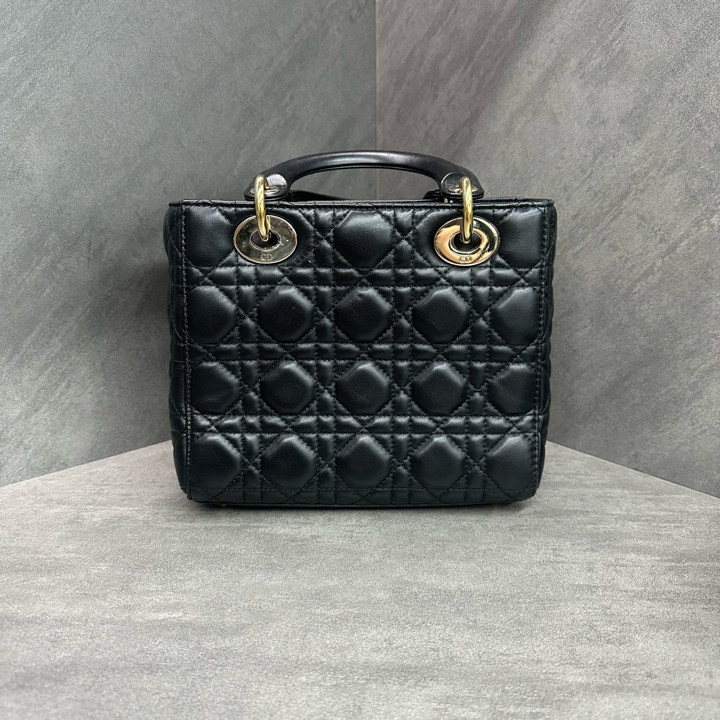 Dior Lady Dior medium (four-compartment) bag in black gold-tone lambskin, produced in 2017, with emblem shoulder strap, structured silhouette, clean interior.