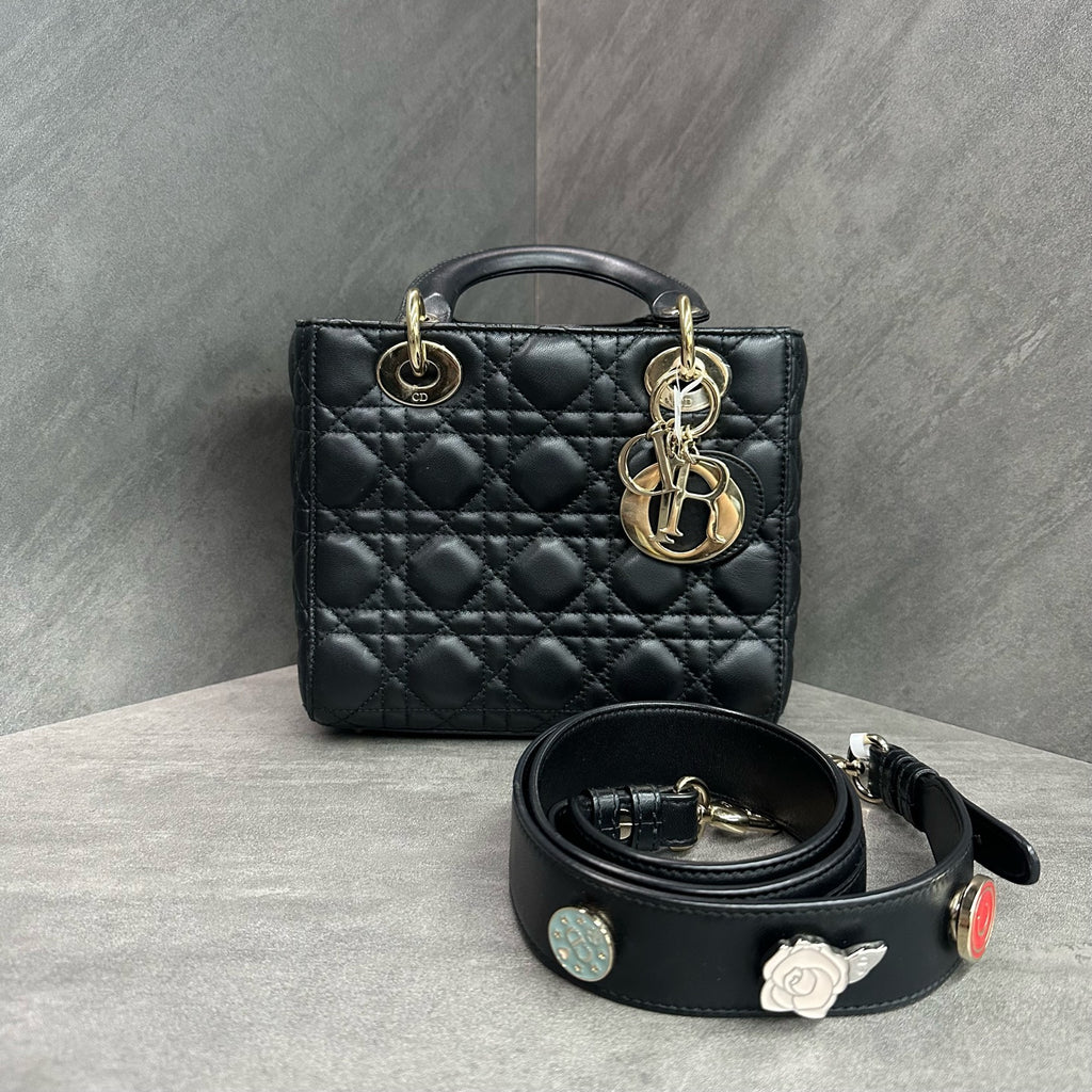 Dior Lady Dior medium (four-compartment) bag in black gold-tone lambskin, produced in 2017, with emblem shoulder strap, structured silhouette, clean interior.