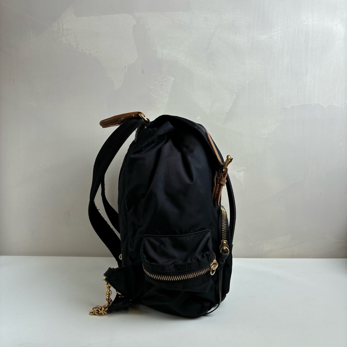 Burberry The Rucksack Series Classic Backpack with Engraving, Classic Black and Gold Color Scheme, Subtle and Sophisticated.