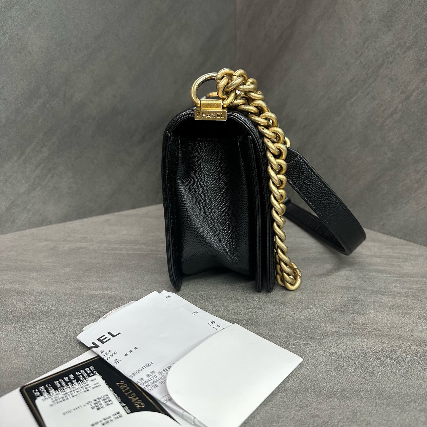 Chanel Le Boy Medium Black Gold Caviar Leather Chain Bag 28 with Card and Receipt. The bag has a structured shape and a clean interior.