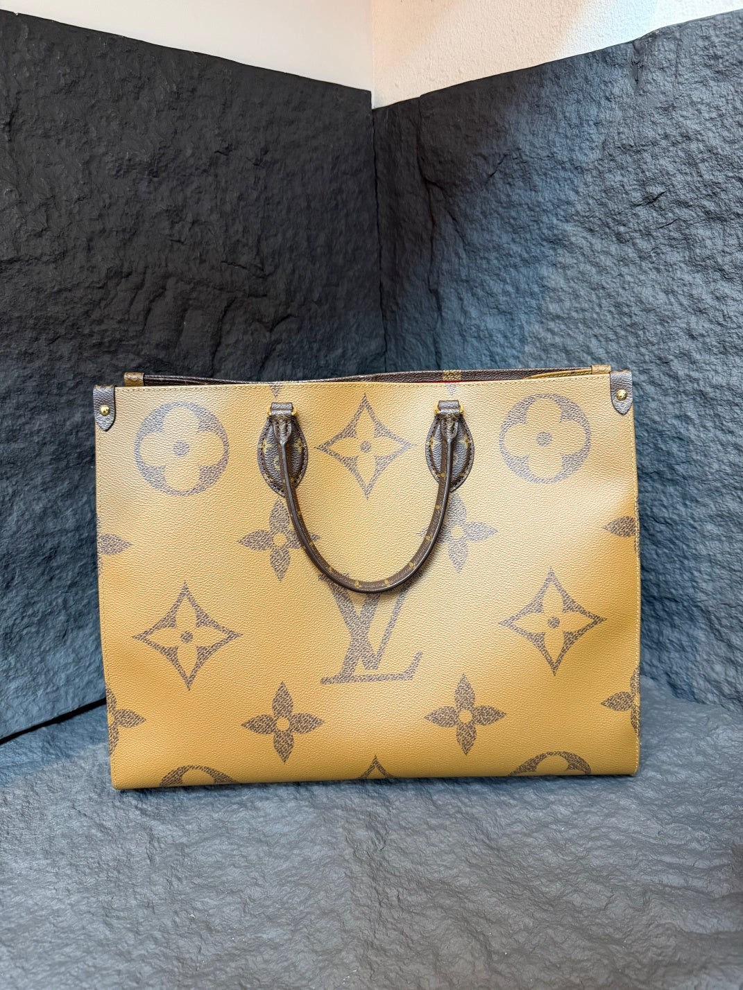 The Onthego handbag stands out in eye-catching Monogram Giant canvas, accented with Mono details on the sides and handles.