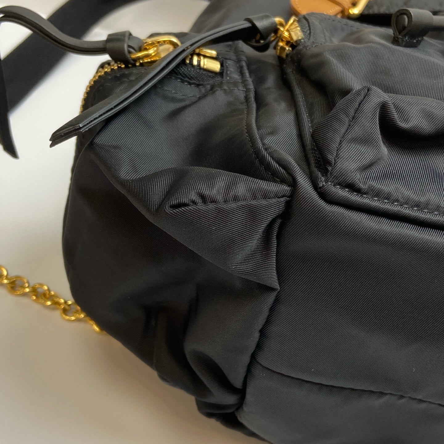 Burberry The Rucksack Series Classic Backpack with Engraving, Classic Black and Gold Color Scheme, Subtle and Sophisticated.