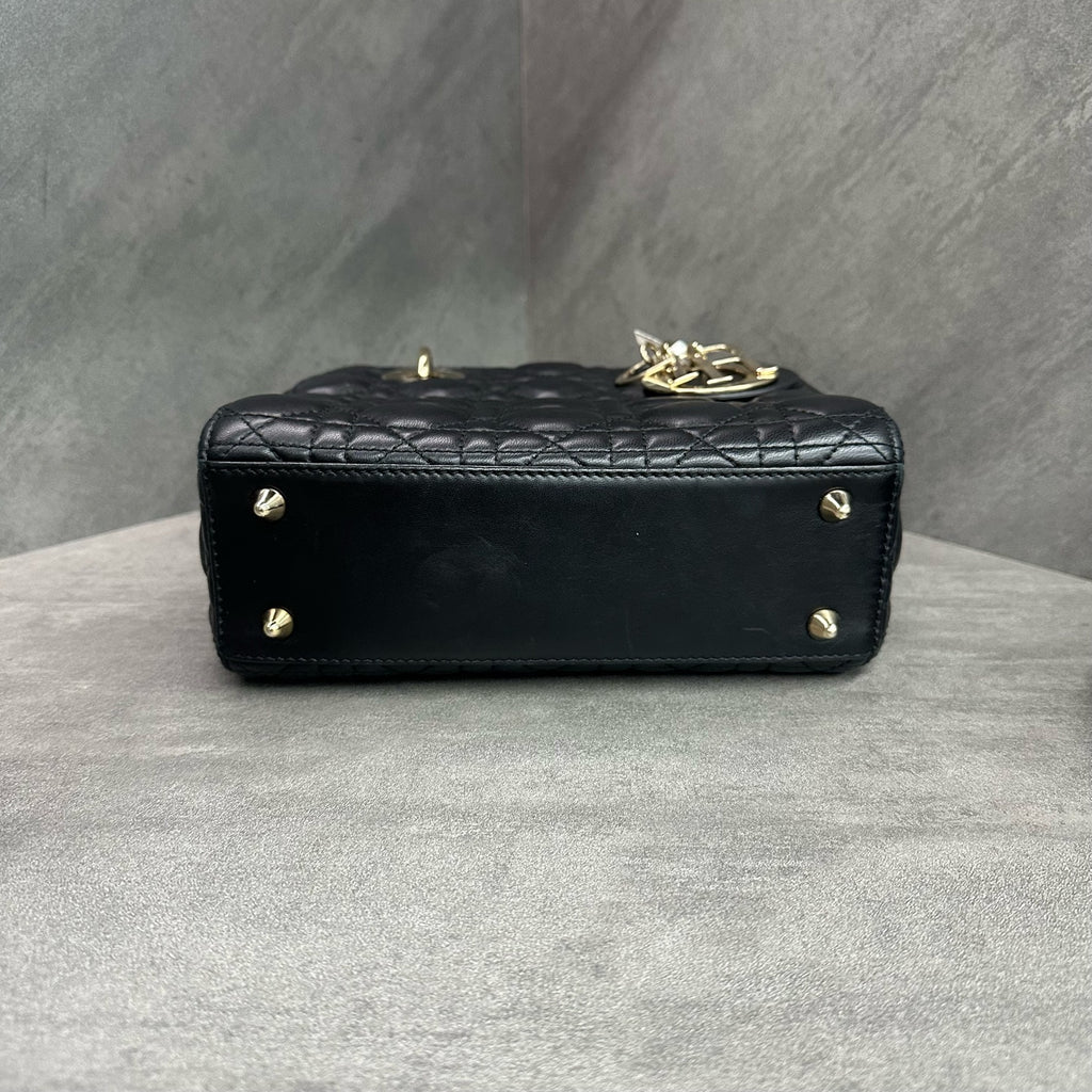 Dior Lady Dior medium (four-compartment) bag in black gold-tone lambskin, produced in 2017, with emblem shoulder strap, structured silhouette, clean interior.