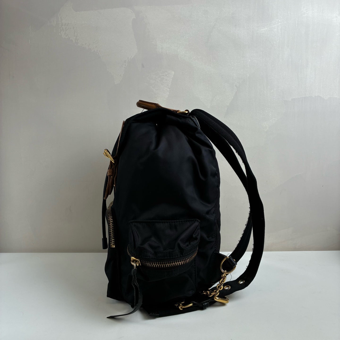 Burberry The Rucksack Series Classic Backpack with Engraving, Classic Black and Gold Color Scheme, Subtle and Sophisticated.